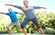 Woman and man doing yoga in the park